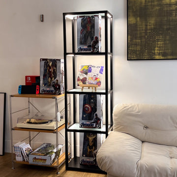 FENLO LED glass display shelf in a living room holding boxed action figures and collectible toys, lit from each tier